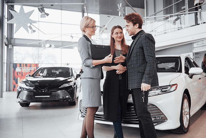 car-dealership-meeting-with-saleswoman-and-couple-2026-01-09-00-39-55-utc.png