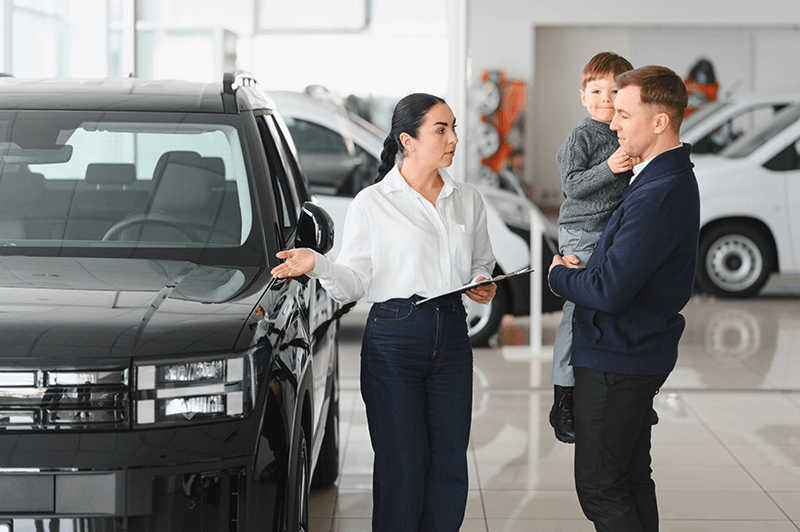 father-and-son-choosing-a-new-car-to-buy-at-the-ca-2026-01-11-10-14-29-utc.png