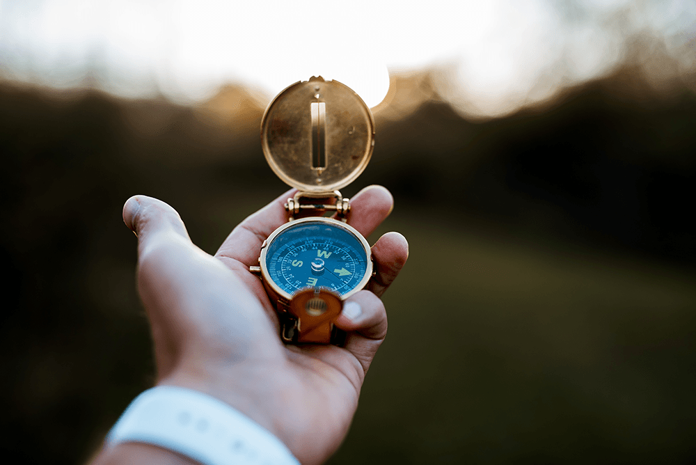 hand-holds-a-golden-compass-in-natural-light-2026-03-18-08-25-58-utc.png