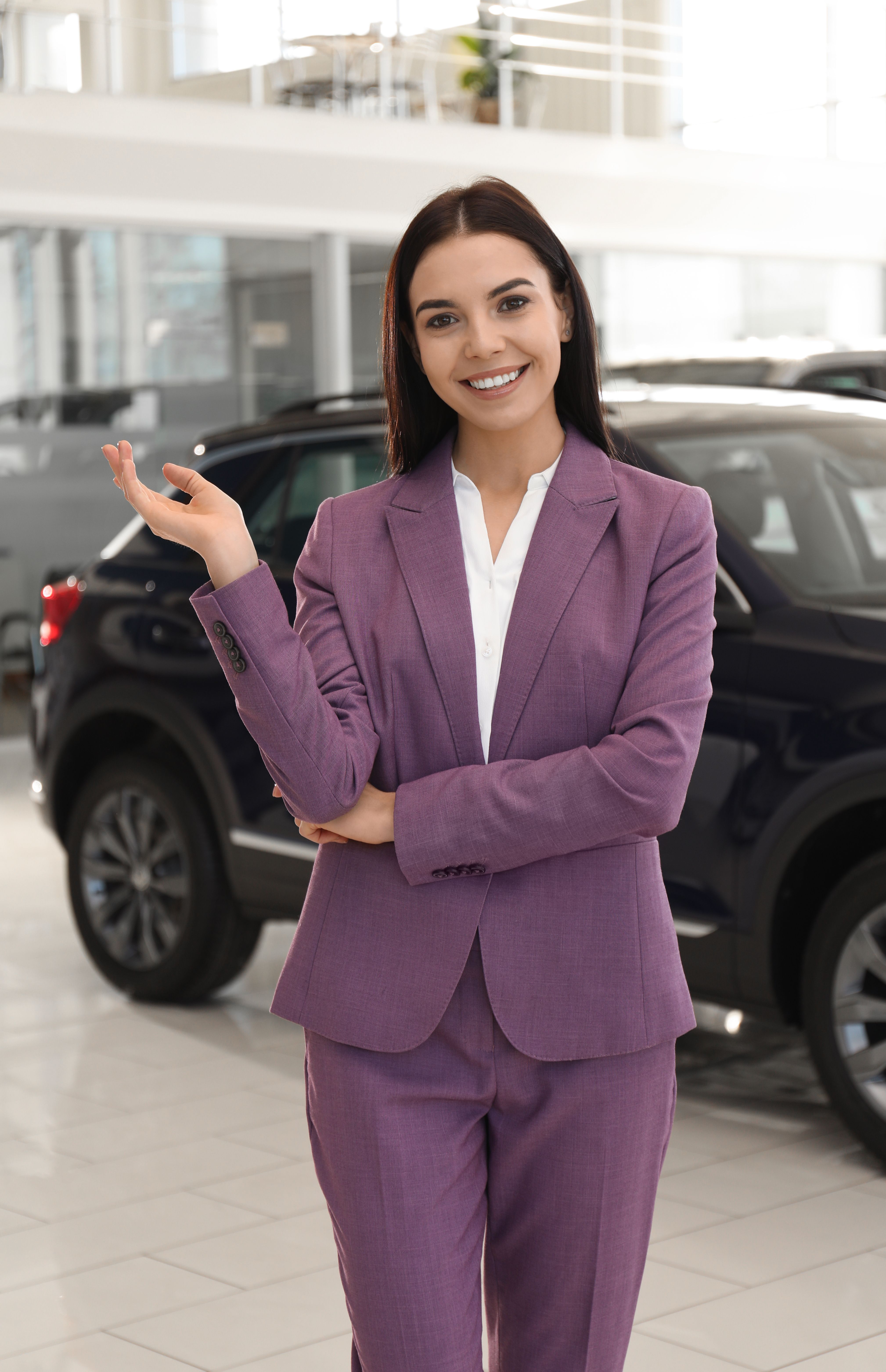 happy-young-saleswoman-in-modern-car-salon-2026-01-23-19-17-41-utc.jpg
