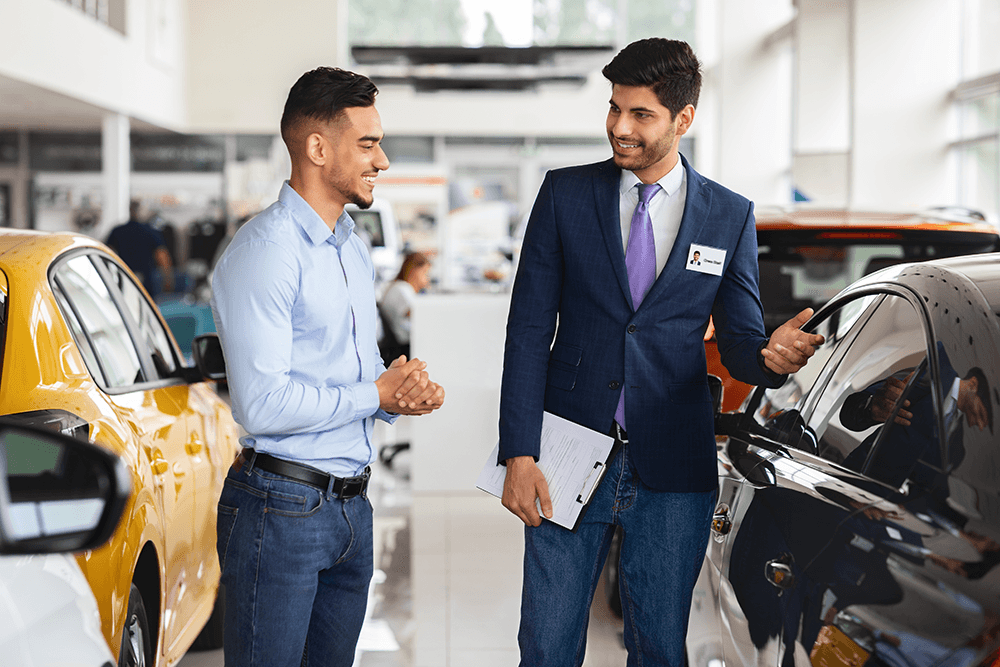 man-consults-with-salesman-at-car-dealership-2026-01-08-23-24-39-utc.png