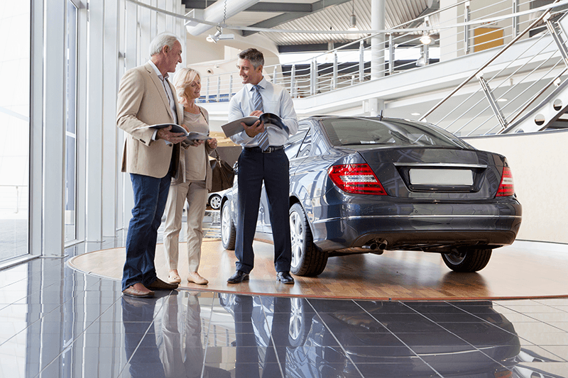 salesman-and-couple-with-brochures-next-to-car-in-2026-01-11-09-39-29-utc.png