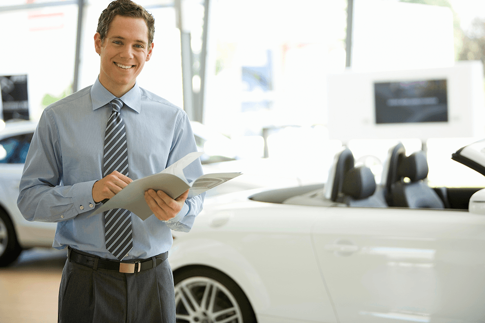 salesman-standing-in-car-dealership-with-an-open-c-2026-01-11-08-43-31-utc.png