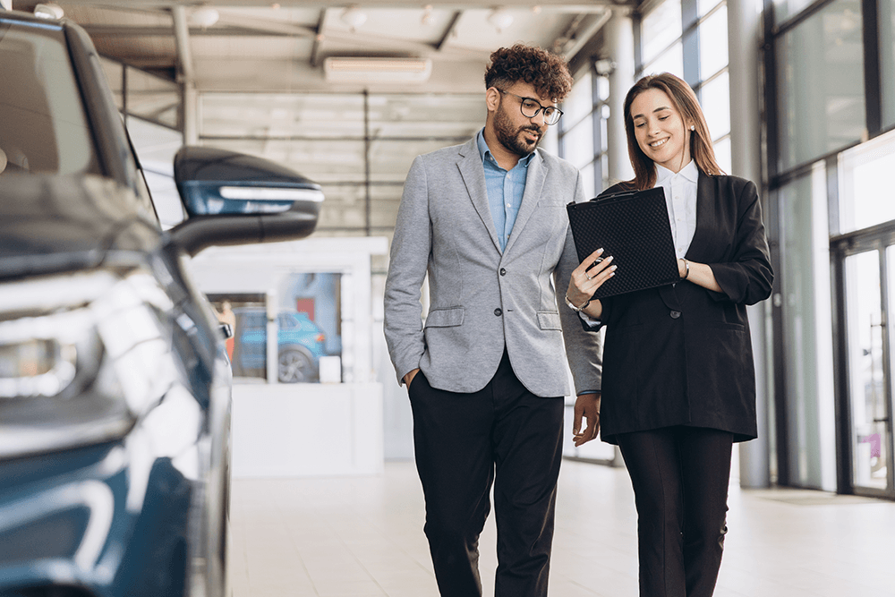 saleswoman-showing-a-car-to-customer-in-a-dealersh-2026-01-09-10-05-35-utc.png