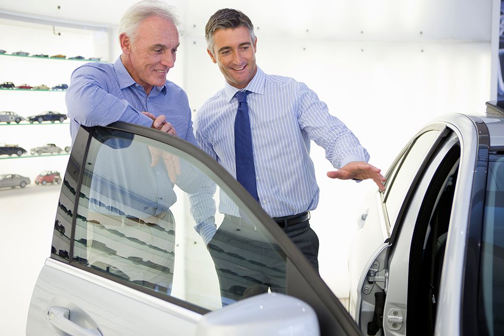smiling-salesman-showing-customer-inside-of-car-in-2026-01-11-09-40-07-utc.jpg